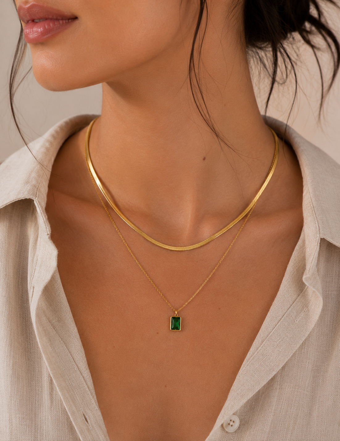 Gold layered necklace set with snake chain and green gem pendant — alternate view