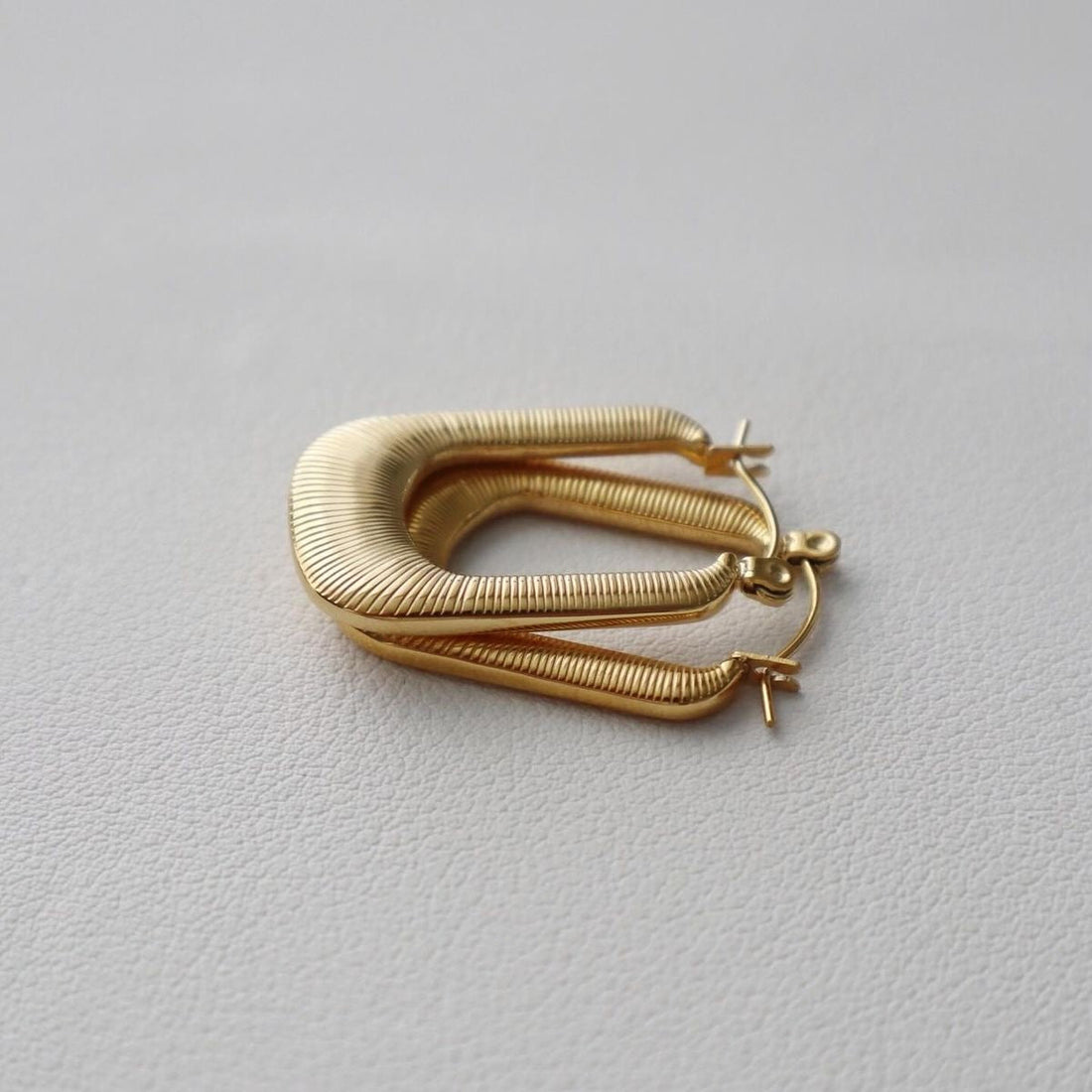 Gold-plated stainless steel hoop earrings close up