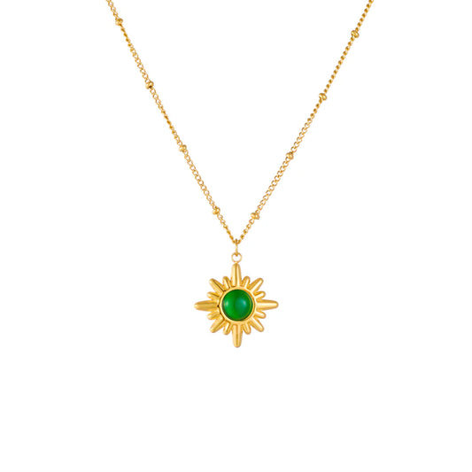 Gold sun pendant necklace with a green gemstone — alternate view