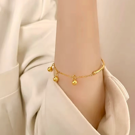 Gold Bangle with Hanging Ball Charms – Elegant and Modern Design