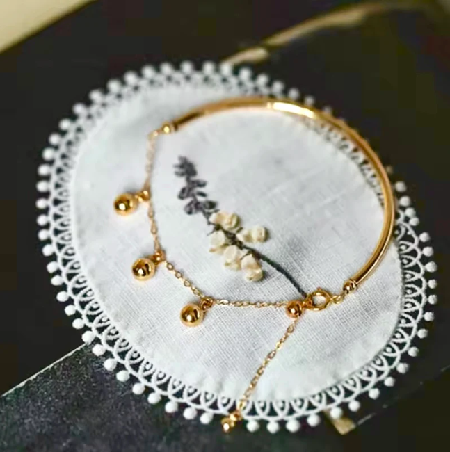 Gold Bangle with Hanging Ball Charms – Elegant and Modern Design
