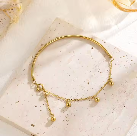 Gold Bangle with Hanging Ball Charms – Elegant and Modern Design