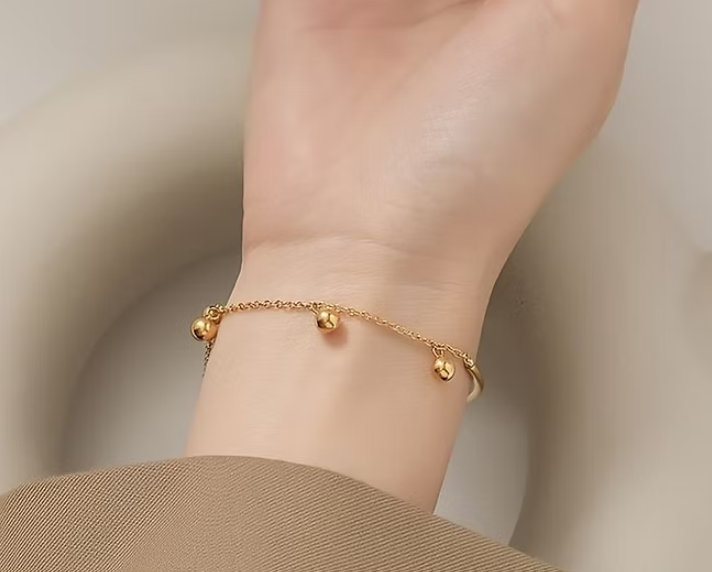 Gold Bangle with Hanging Ball Charms – Elegant and Modern Design