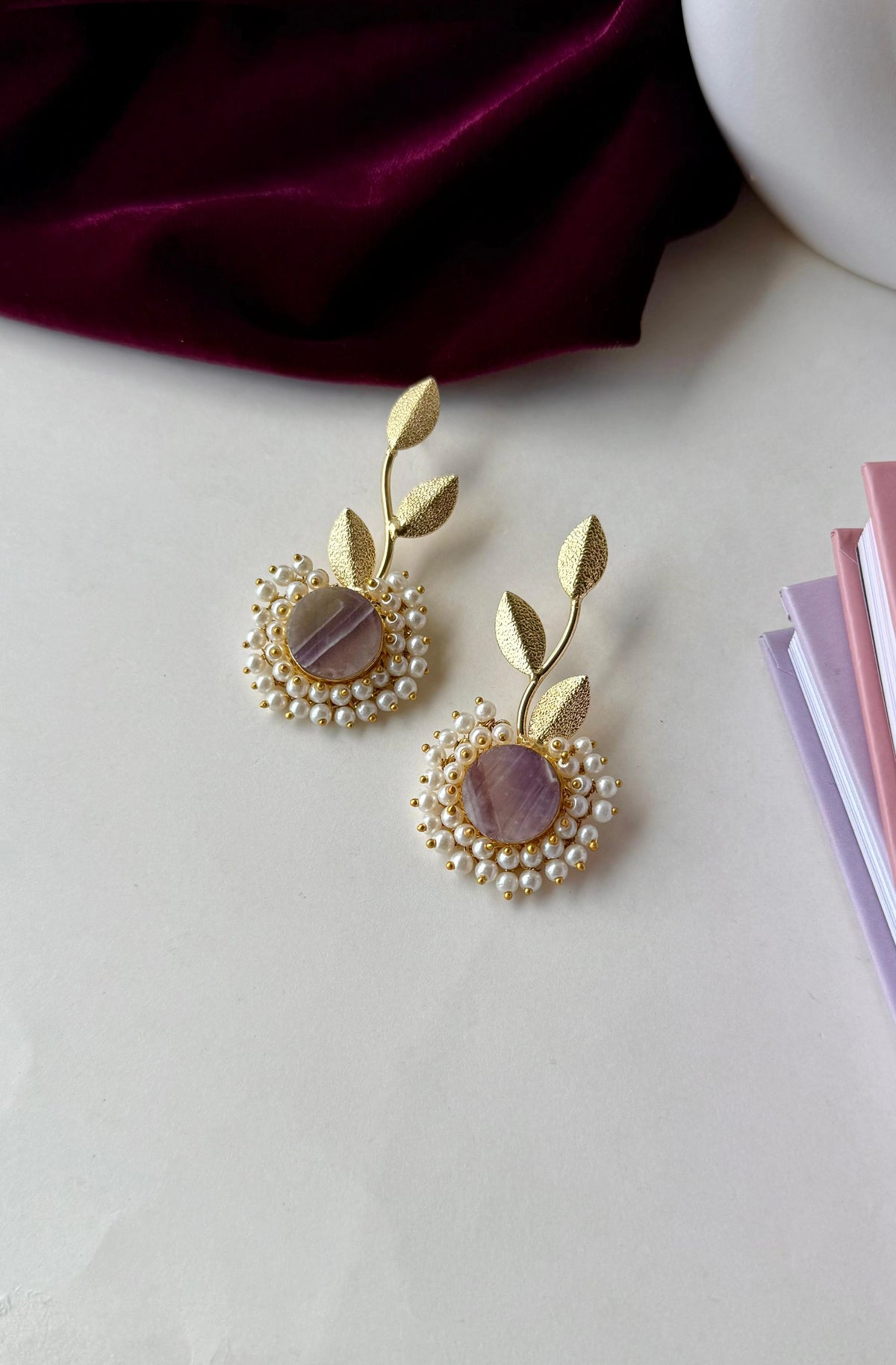 Brass leaf motif earrings with a pearl and stone centre — alternate view