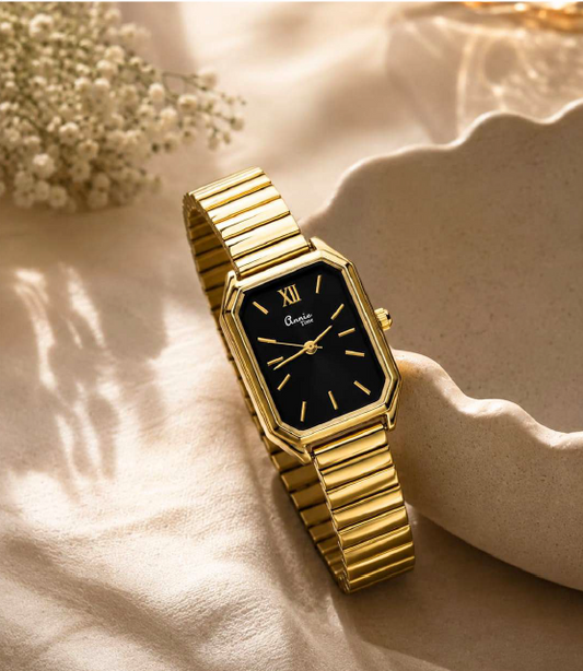 Gold rectangular women's watch with a black dial