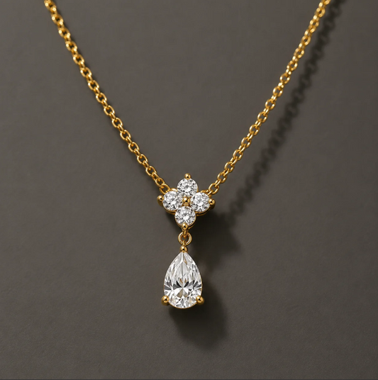 Gold-plated pendant necklace with a floral crystal setting and teardrop