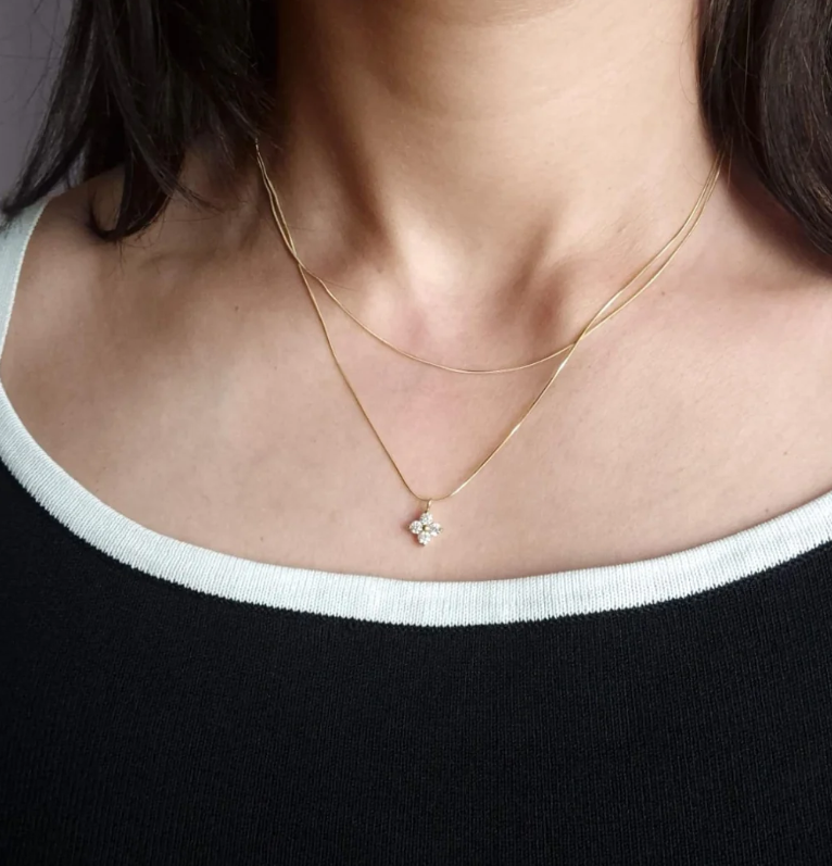 Gold layered necklace with a clover crystal flower pendant — alternate view